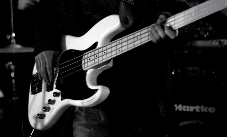 man playing bass electric guitar