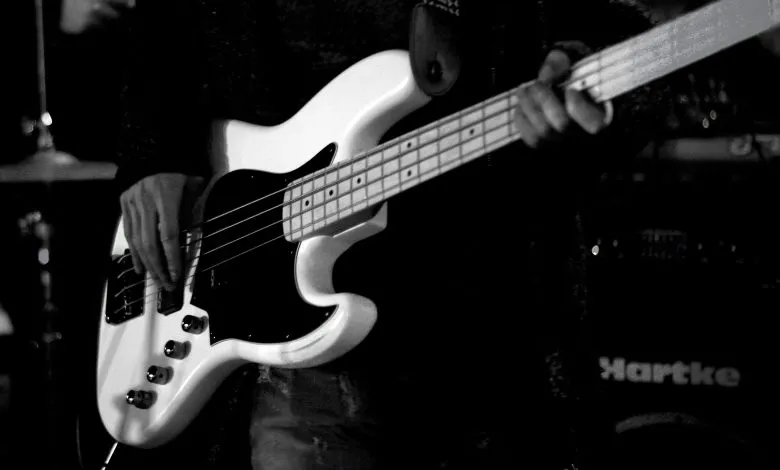 man playing bass electric guitar